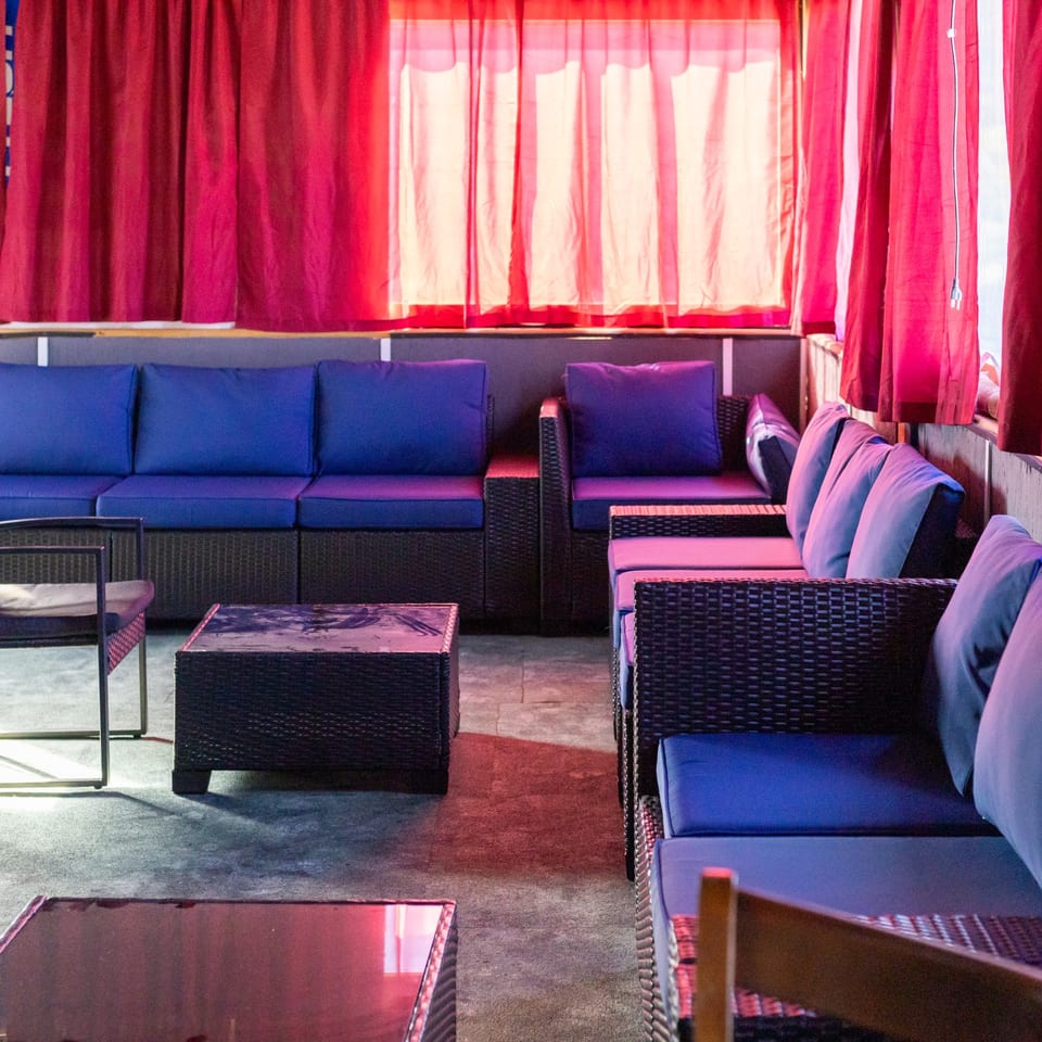 Lounge seating with red curtains