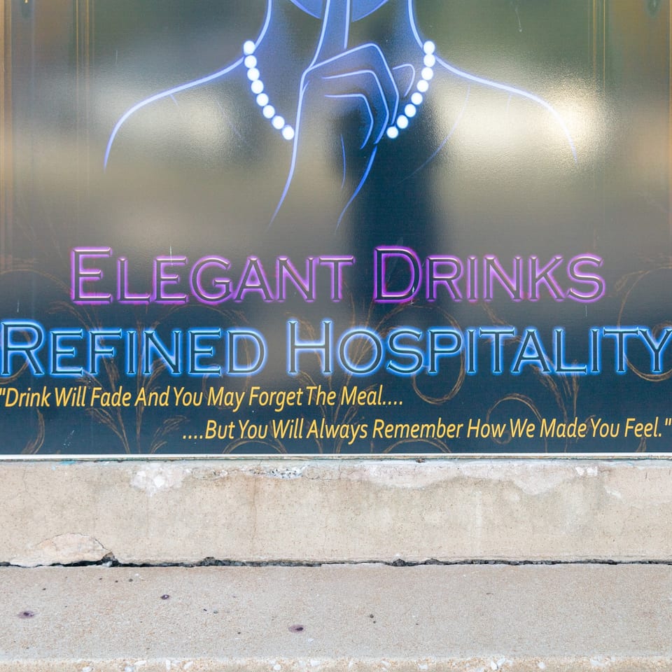 Elegant Drinks and Refined Hospitality window sign