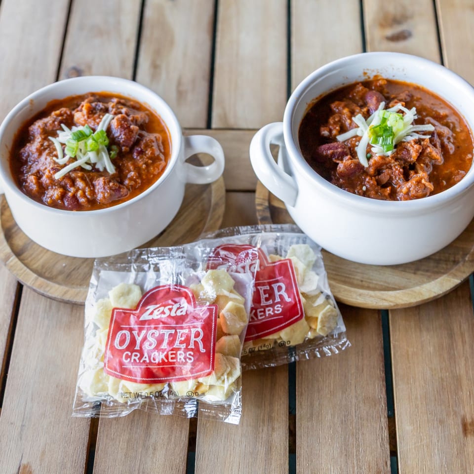 Bowls of chili on a wooden table