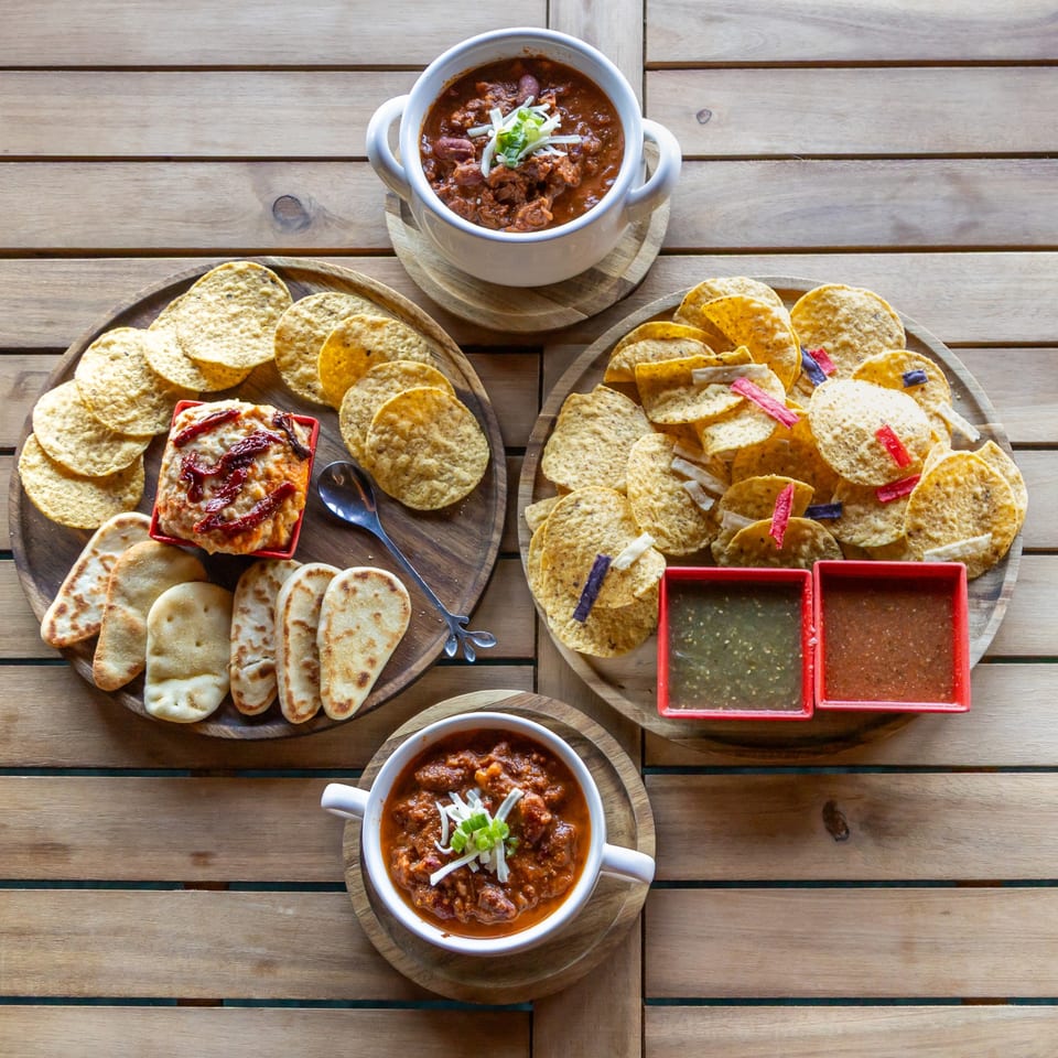 Chili, hummus and chips on serving boards