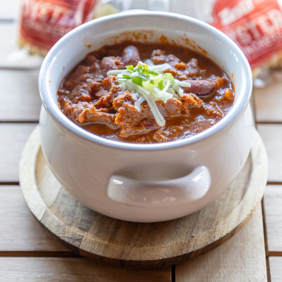 House chili topped with cheese and green onions